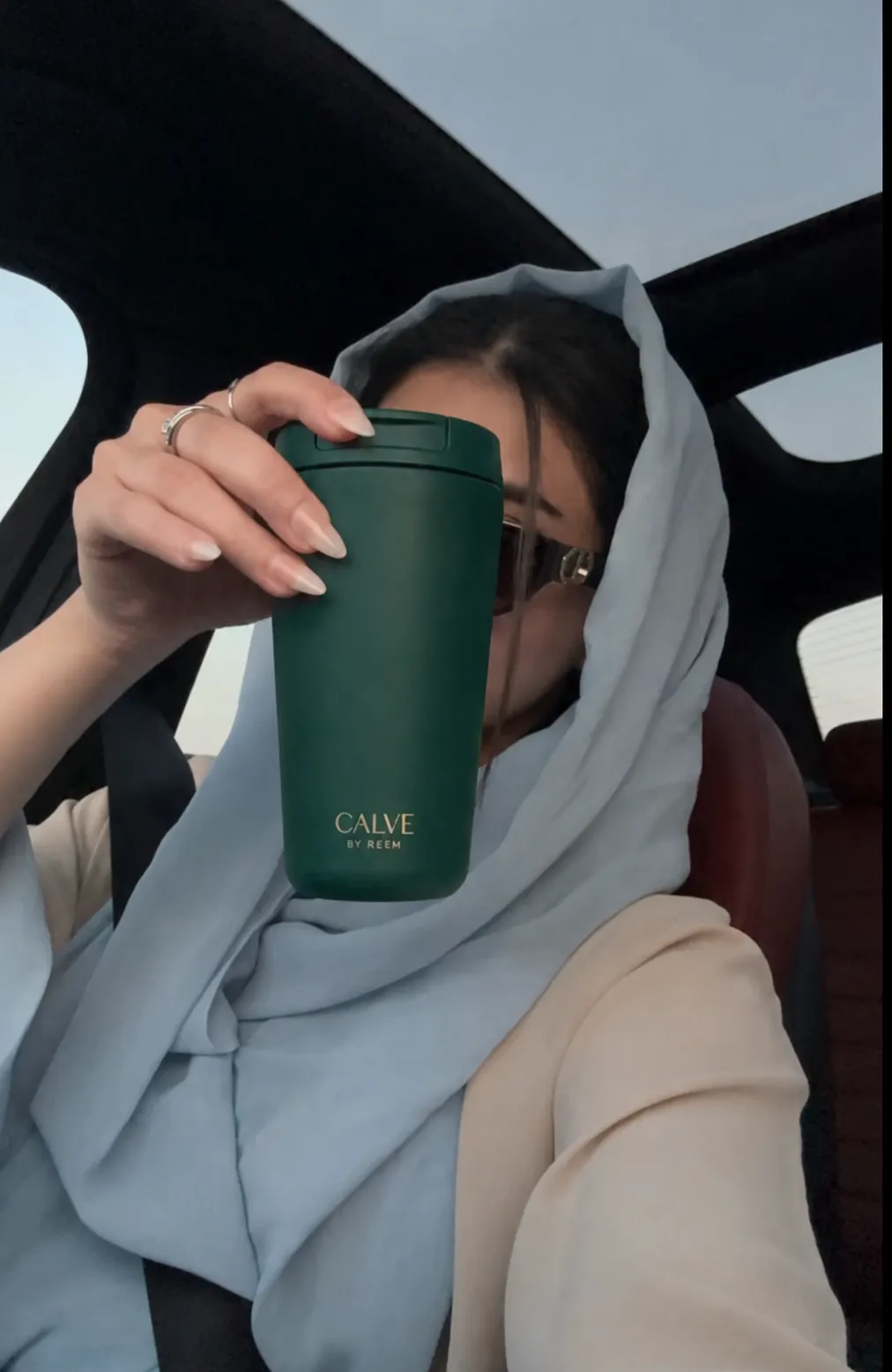 CALVE forest green tumbler styled in the city